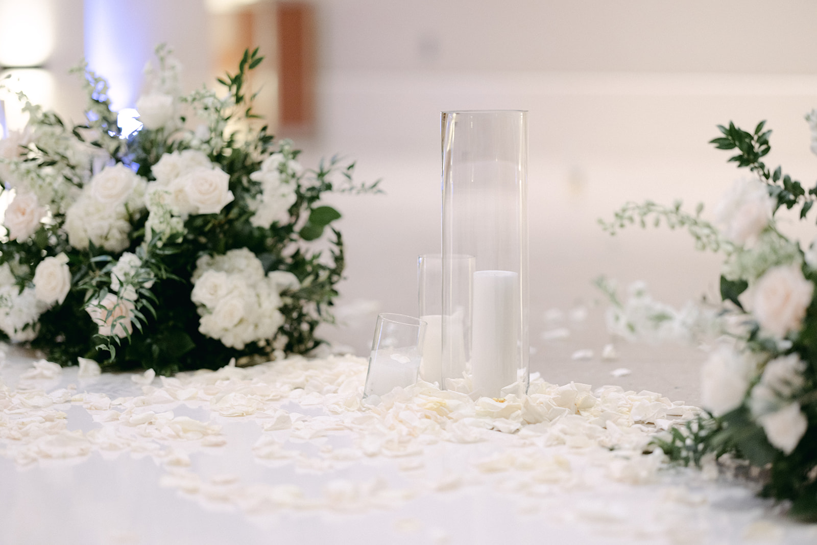 Hurricane glass candles and white rose florals 