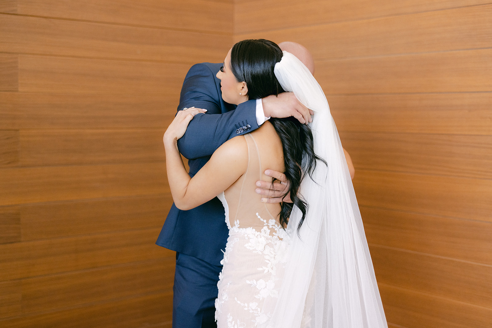 Dad hugging bride after seeing her for first look on wedding day 