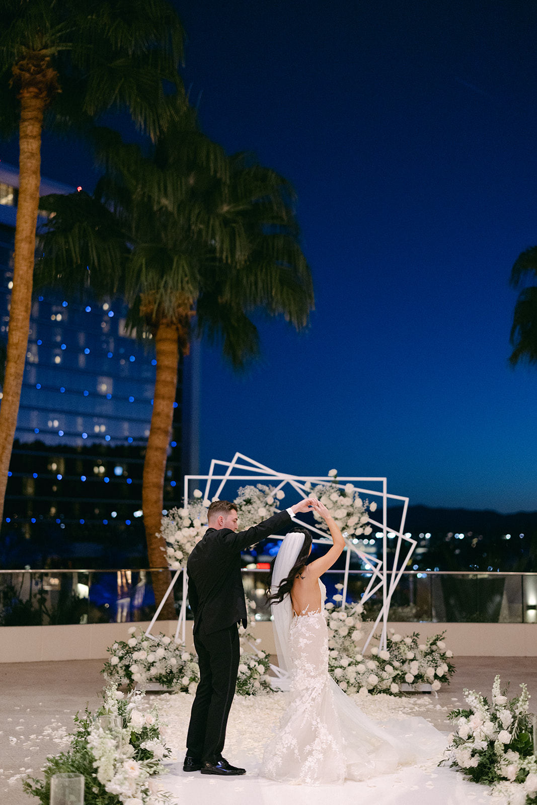 Bride and Groom dancing with night sky in the background on Red Rock Casino terrace 