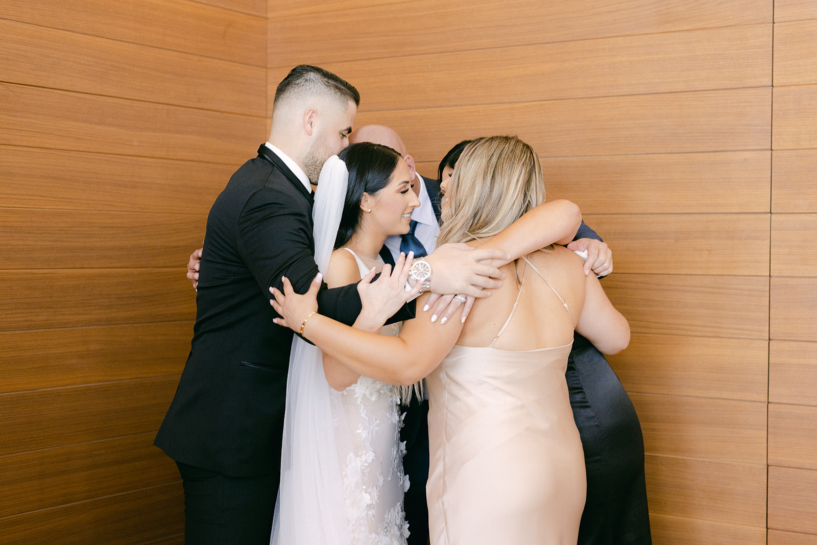 Group hug with family while getting ready for wedding 