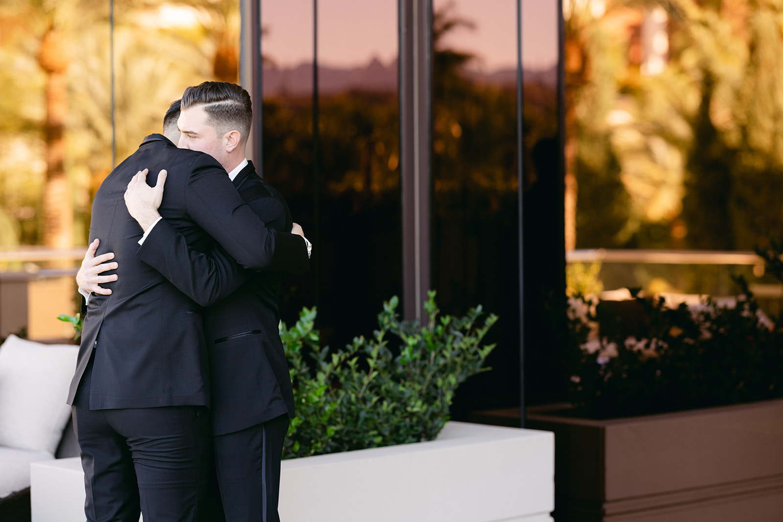 Groomsen hugging groom before he sees the bride for the first time 