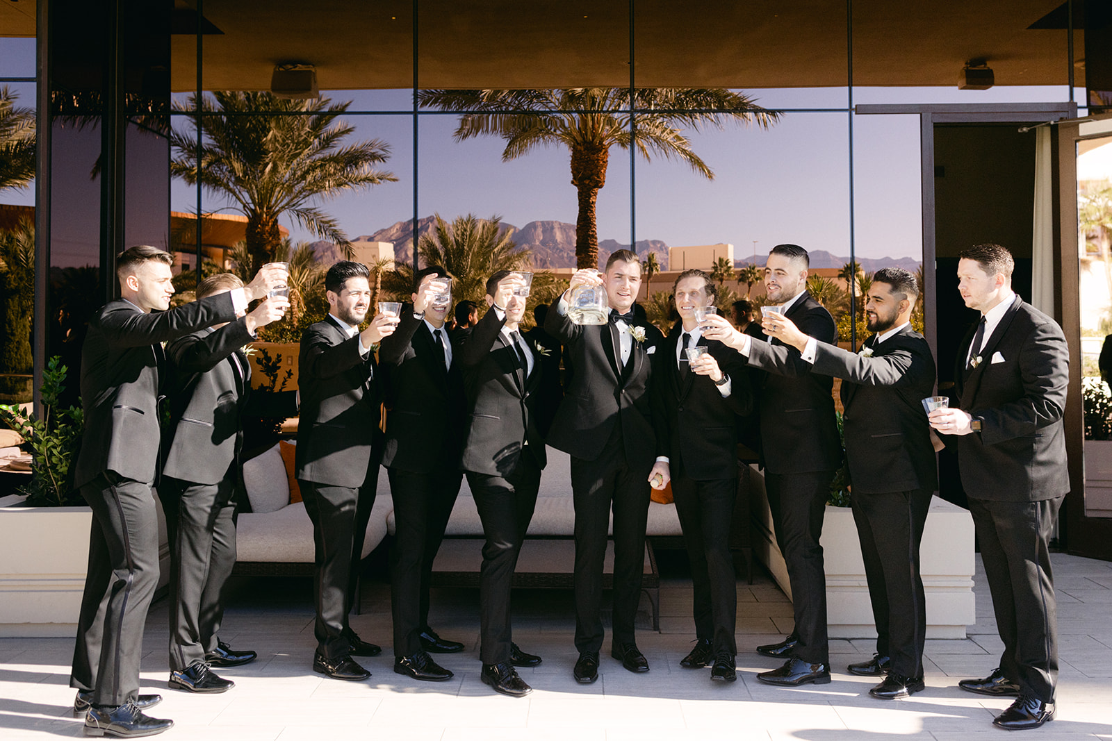 Groomsmen doing a cheers while getting ready 
