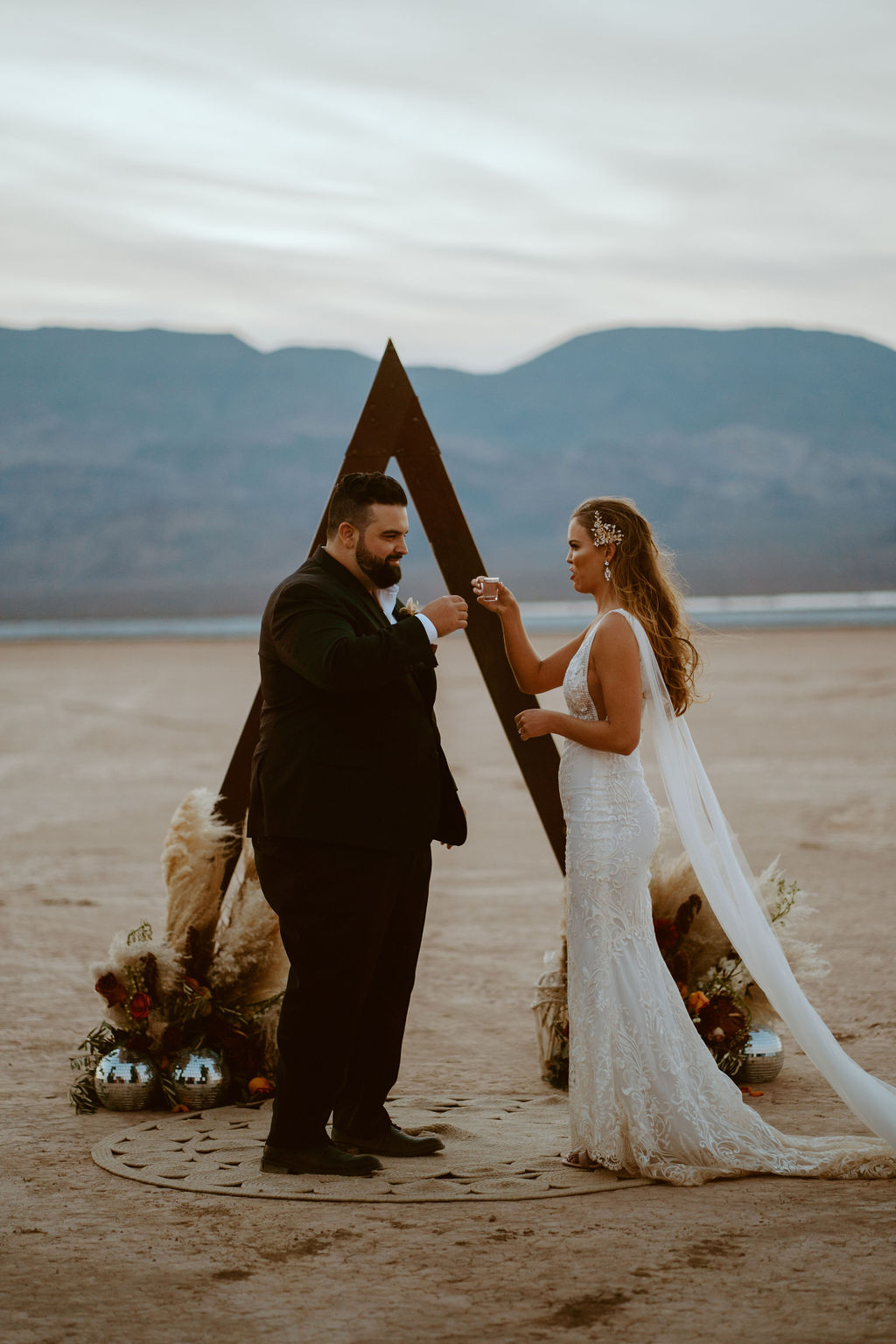 Couple Taking Shots for Unity Shot Ceremony in Las Vegas Desert for Retro Disco Bohemian Micro-Wedding