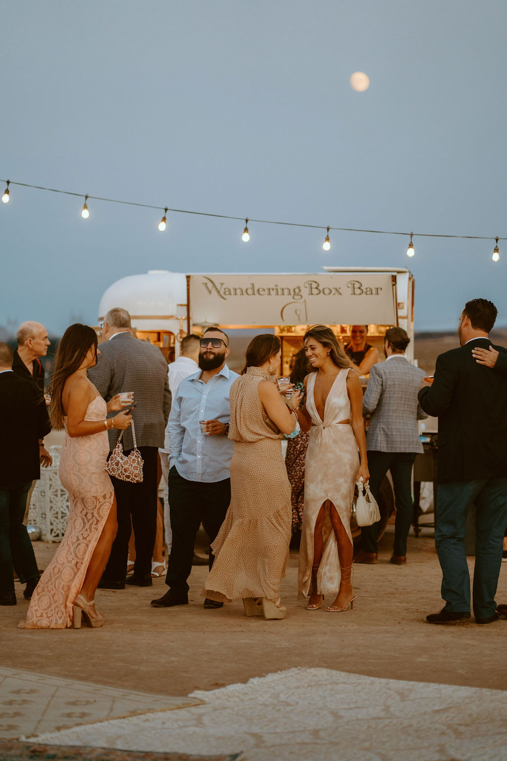 Wandering Box Bar with Bistro Lighting and Moon while Guests Drink