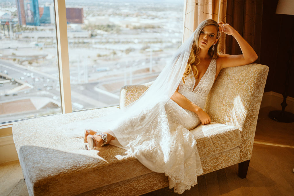 Bride on Lounge Chair in Las Vegas Hotel While Getting Ready for Retro Disco Bohemian Micro-Wedding