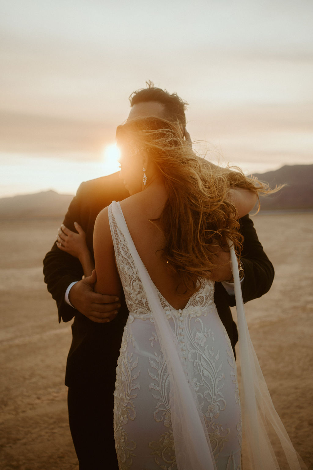 Bride and Groom Hugging During Sunset in Desert 