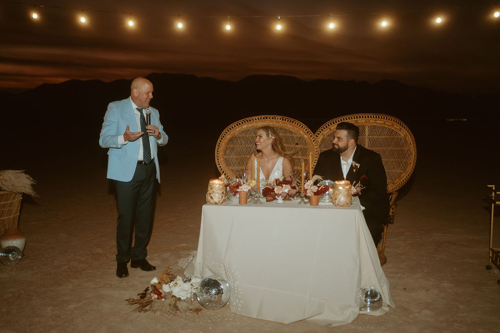Father doing Speech next to Couple at Sweetheart Table in Las Vegas Dry Lake Bed 