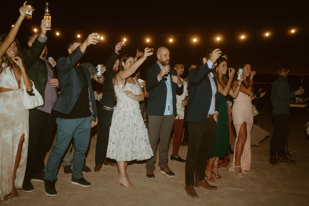 Crowd doing Champagne Toast at Retro Disco Bohemian Micro-Wedding