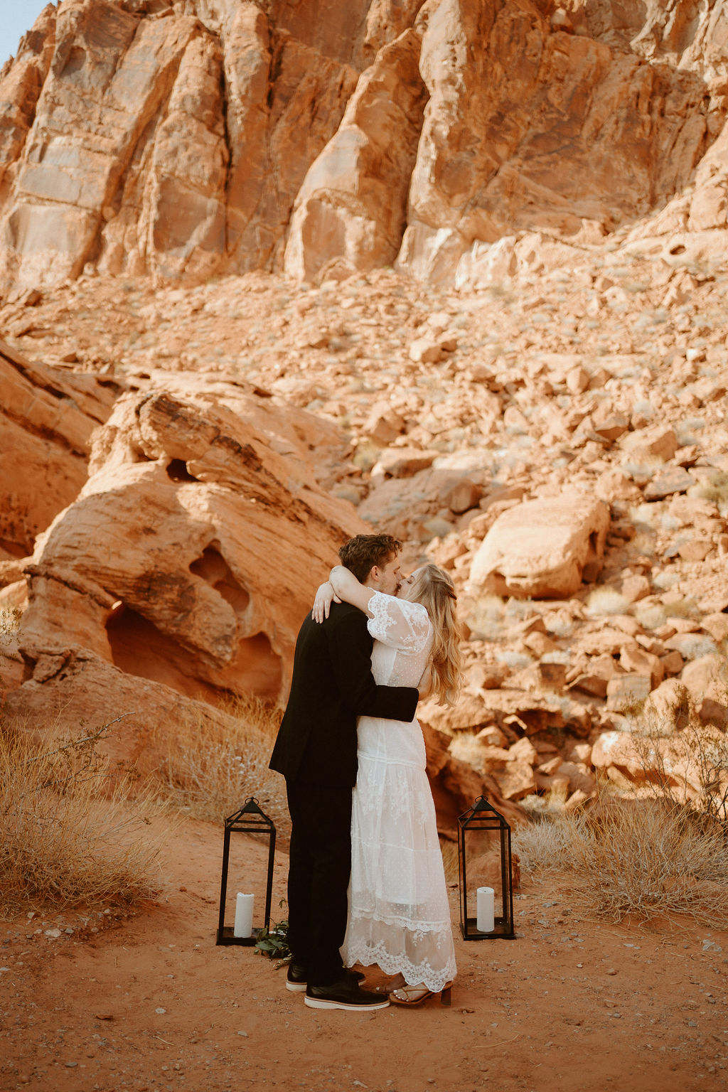 Bride & Groom Sharing First Kiss at Altar with Lanterns during Rolling out in Style in the Desert Elopement Near Las Vegas 