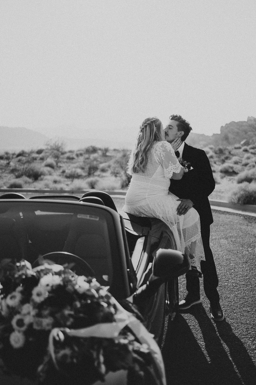 Bride & Groom Kissing on Porsche during Rolling out in Style in the Desert Elopement 