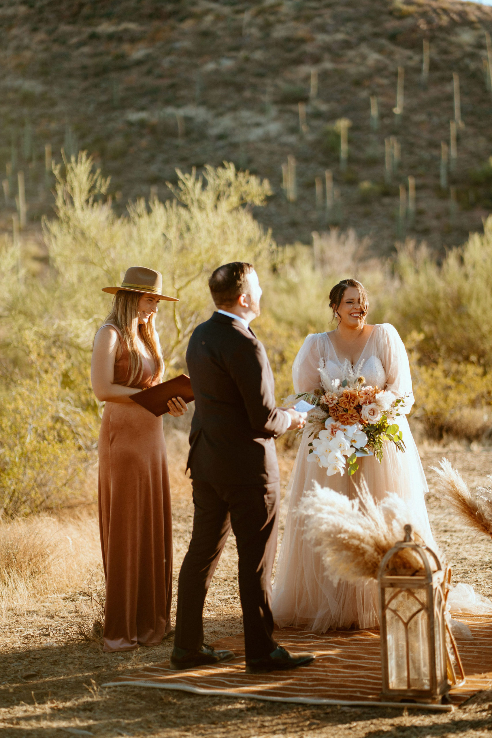 Saguaro National Park Micro-Wedding. The bride and groom laughing at the grooms personal vows 