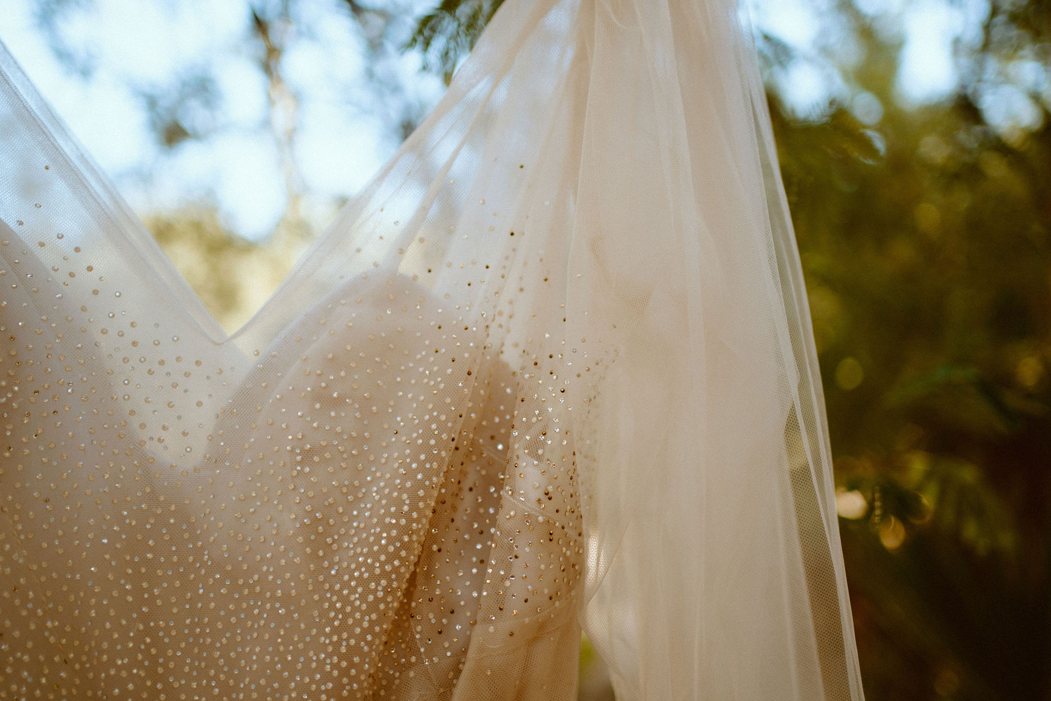 Close up photo of the brides dress to see the detailing of the gems
