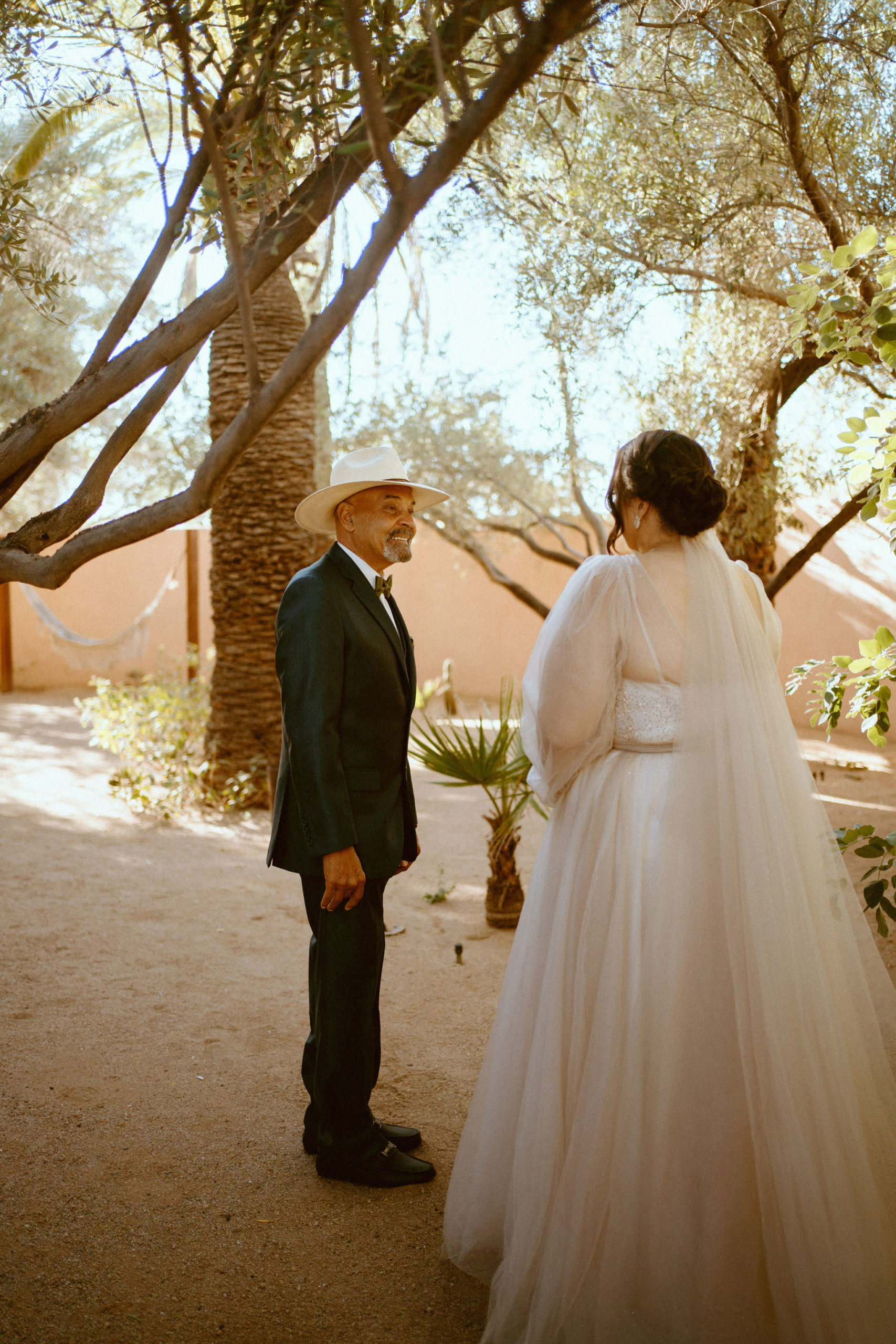 Saguaro National Park Micro-Wedding. The father of the bride smiling as he turns to see the bride all dressed up