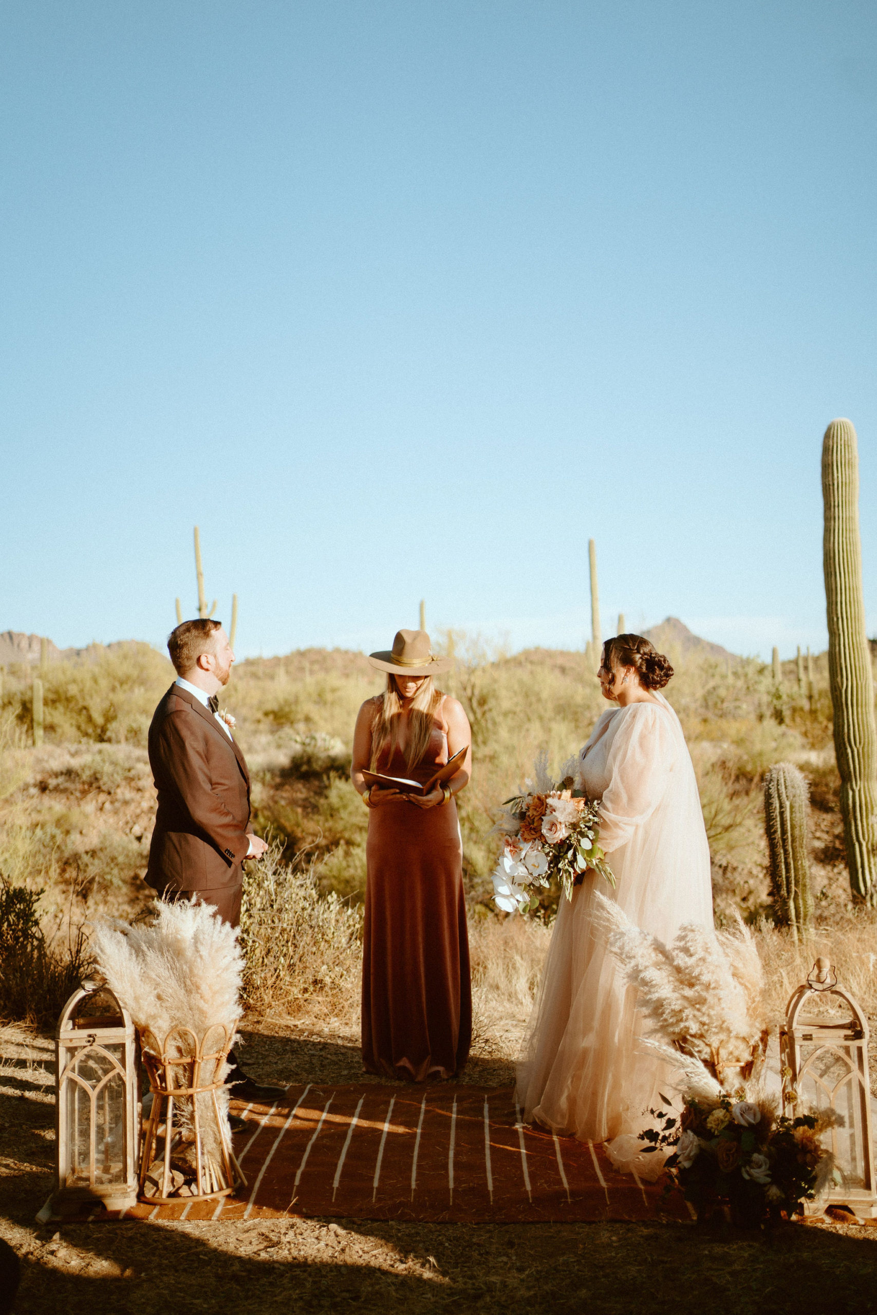 Saguaro National Park Micro-Wedding. Newlyweds standing at the altar as the officiant marries the happy couple