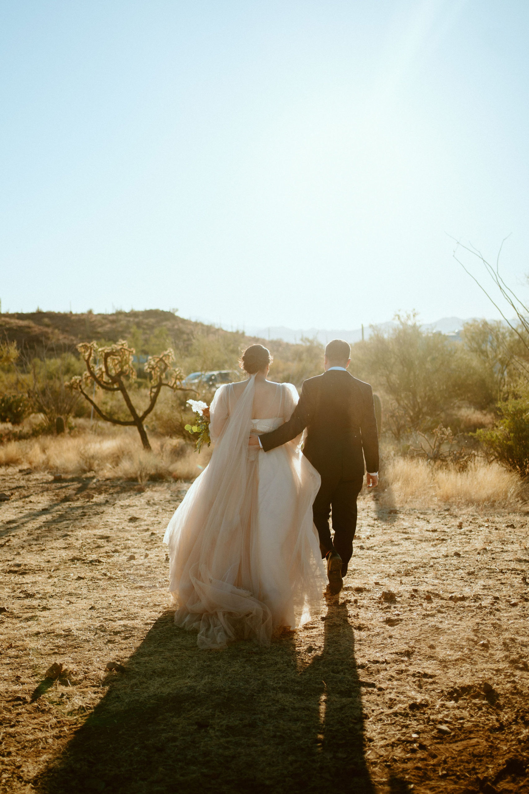 Saguaro National Park Micro-Wedding. The newlyweds walking off into the sunset desert