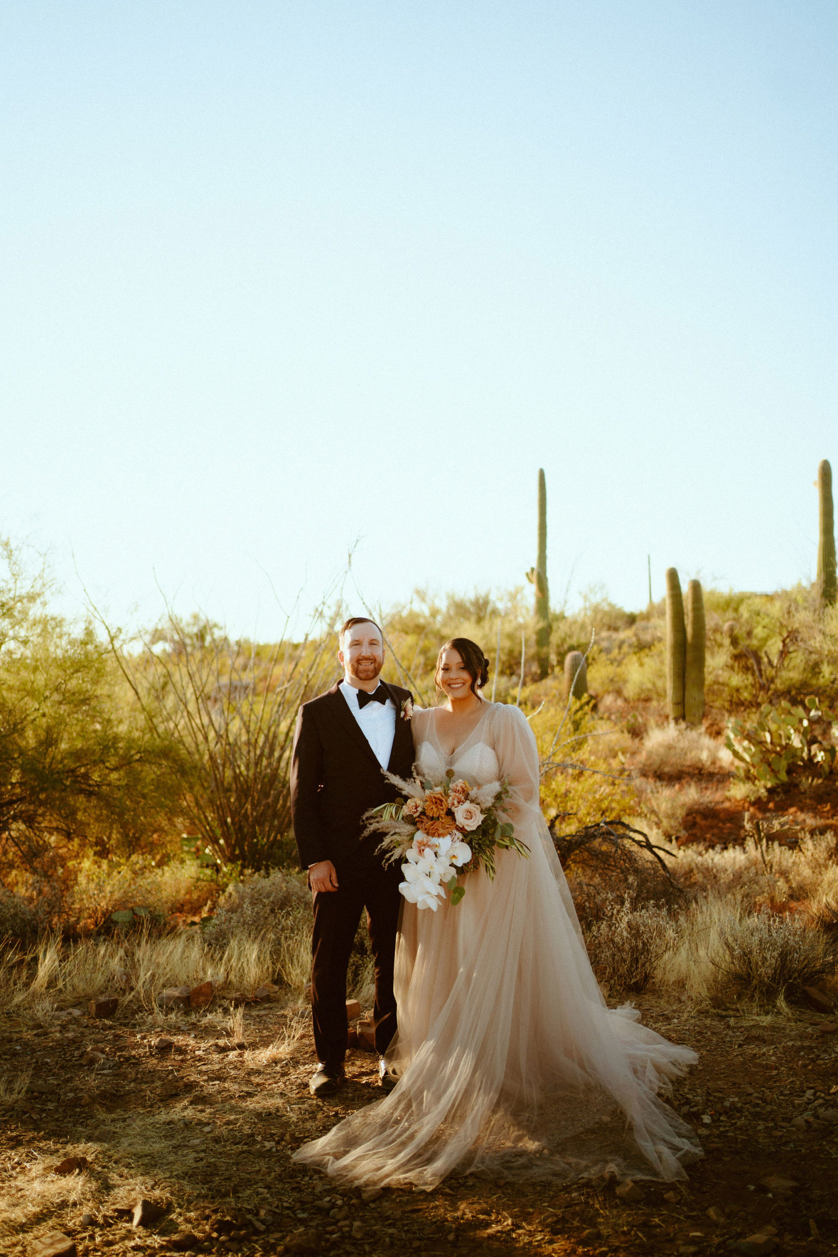 Saguaro National Park Micro-Wedding. The happy newlyweds pose for some newlywed photos in the desert