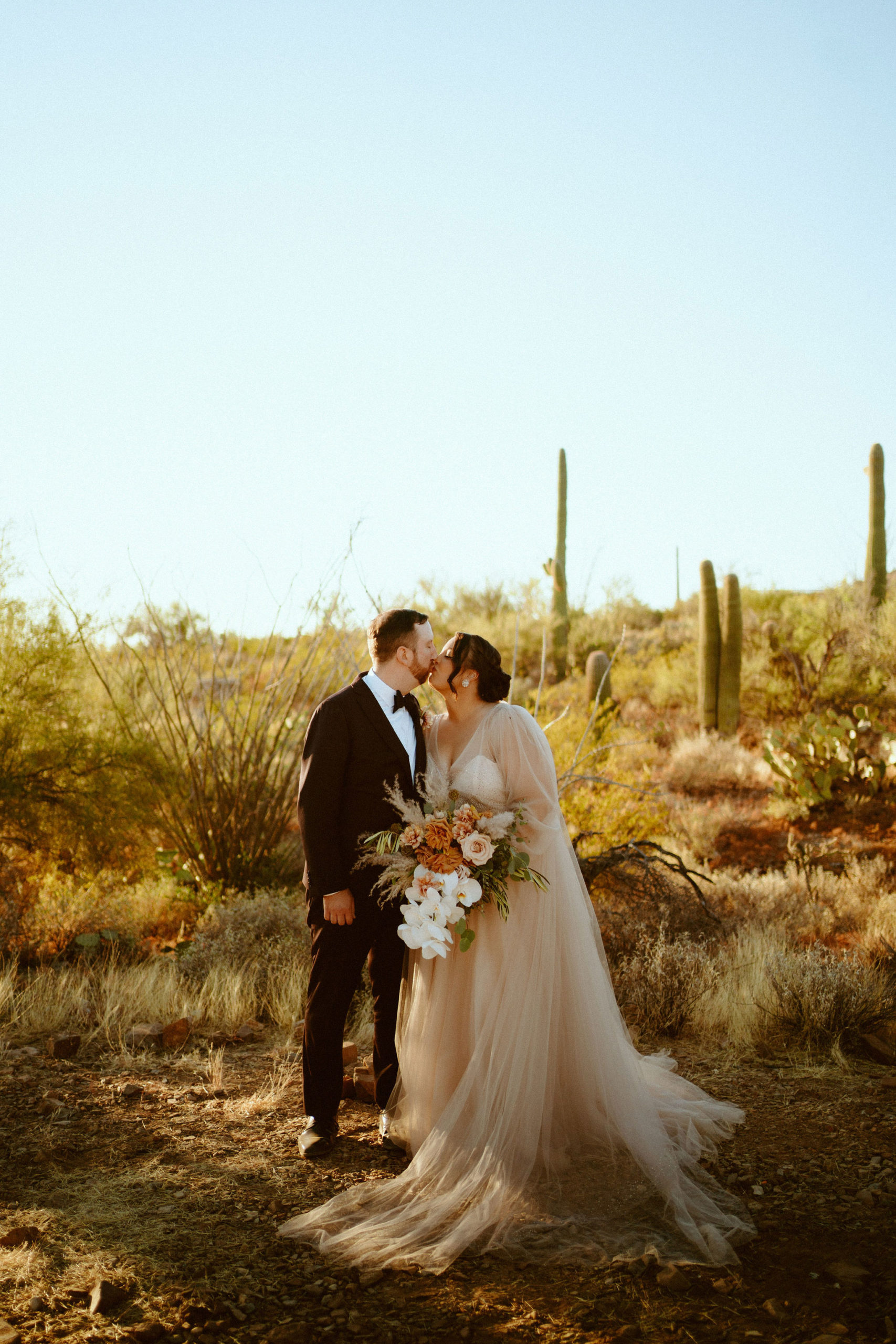 Saguaro National Park Micro-Wedding. The happy newlyweds kiss in the middle of the desert