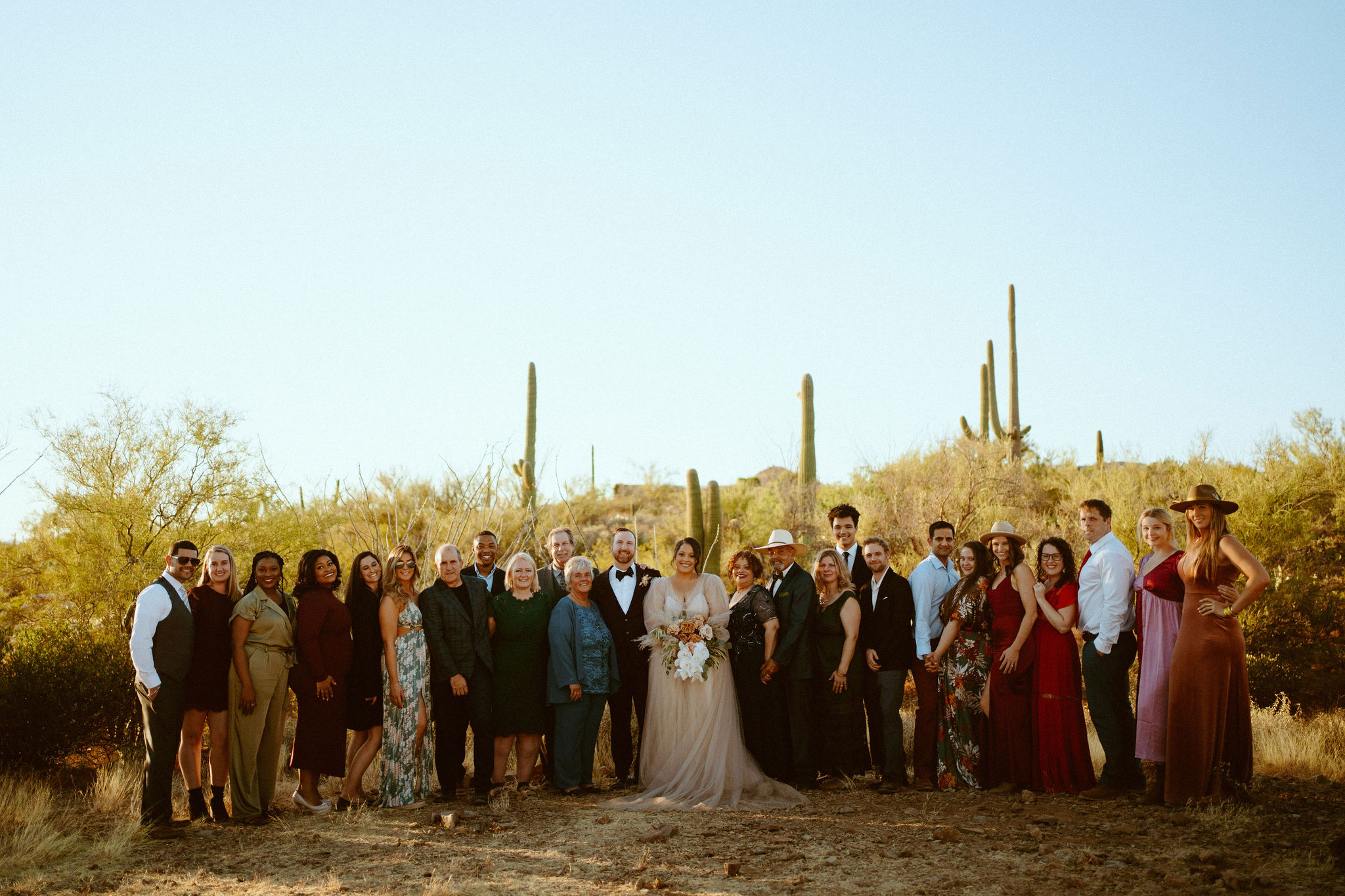 Saguaro National Park Micro-Wedding. Friends and family gather next to the bride and groom at the altar 