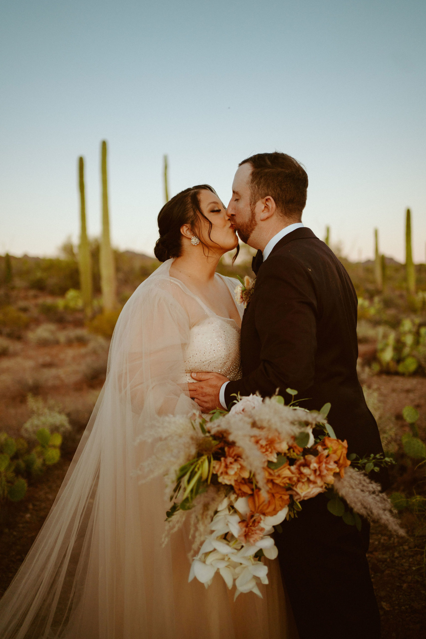 Saguaro National Park Micro-Wedding. Newlyweds kissing in the desert
