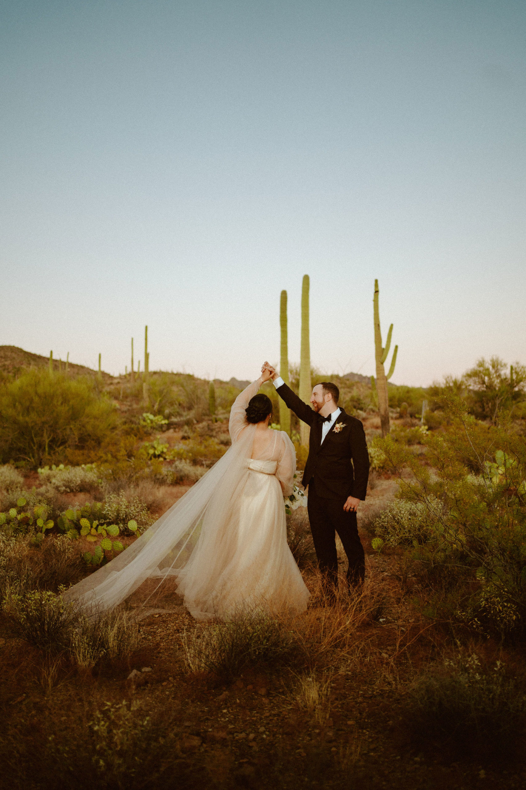 Saguaro National Park Micro-Wedding. Groom spinning his bride in the middle of the Saguaro national park 