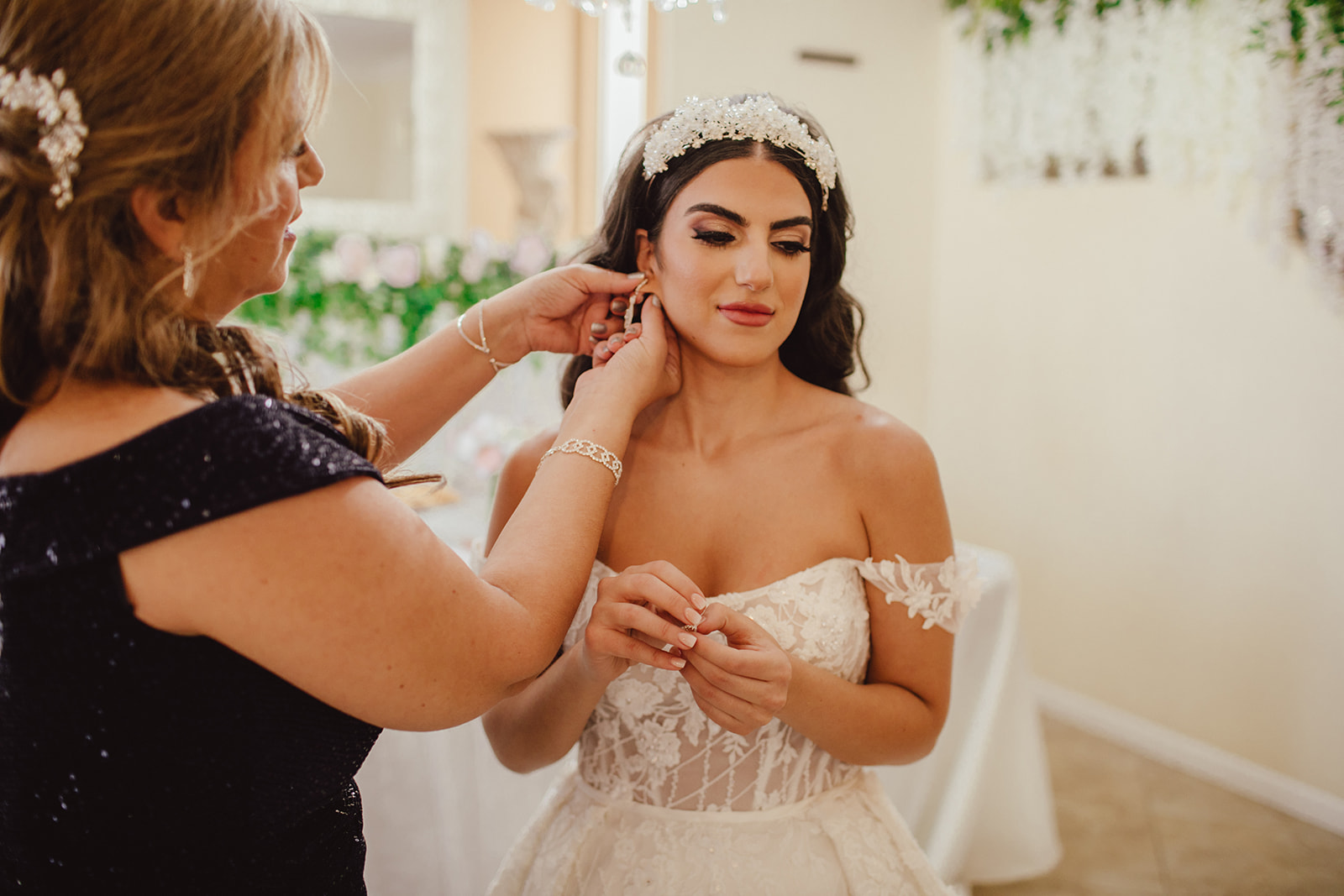 Mother putting on Brides Earrings for Wedding Day 