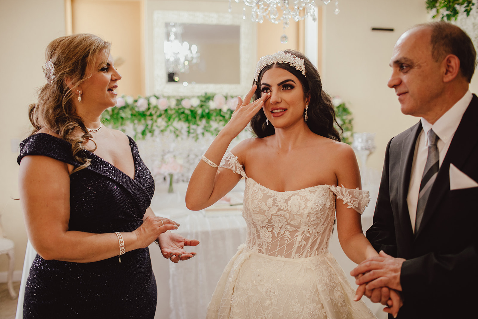 Bride Tearing up with Parents 