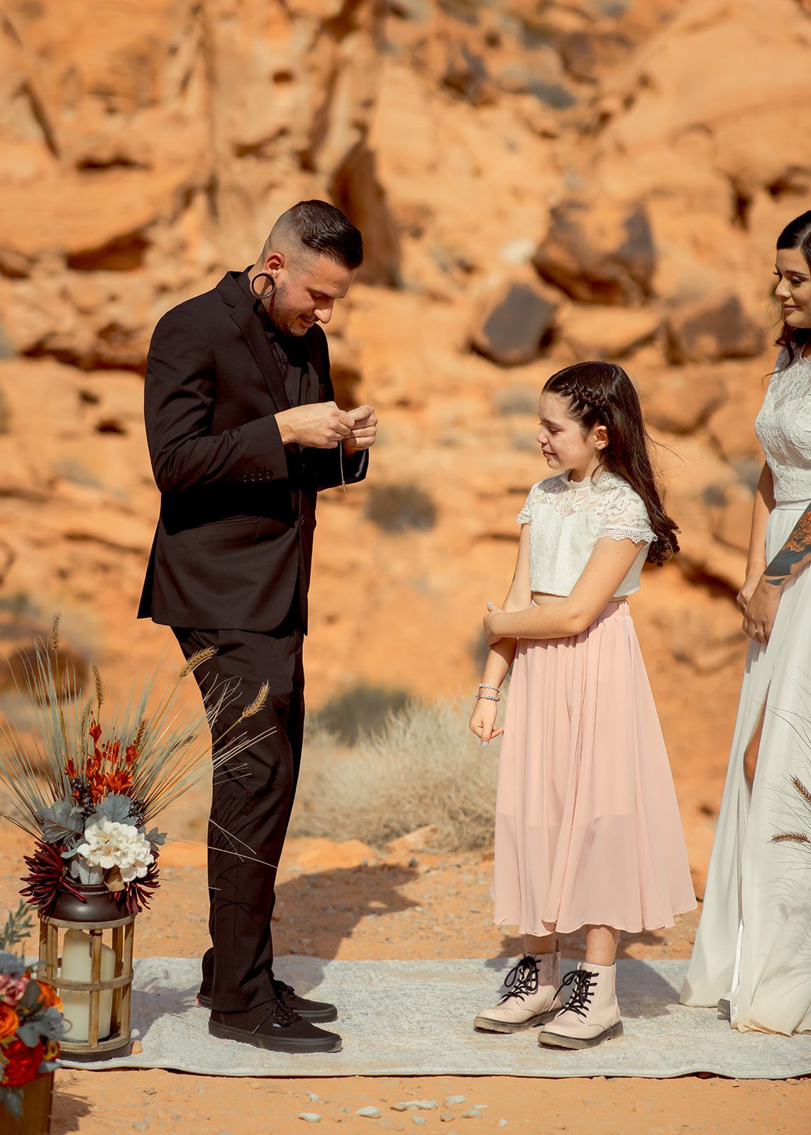 Groom giving daughter gift during elopement ceremony