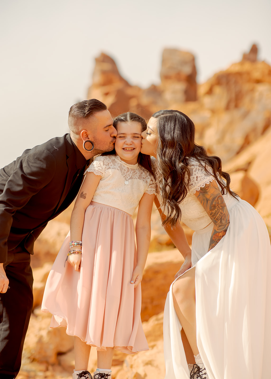 Bride and Groom Kissing Daughters Cheek after getting Married 