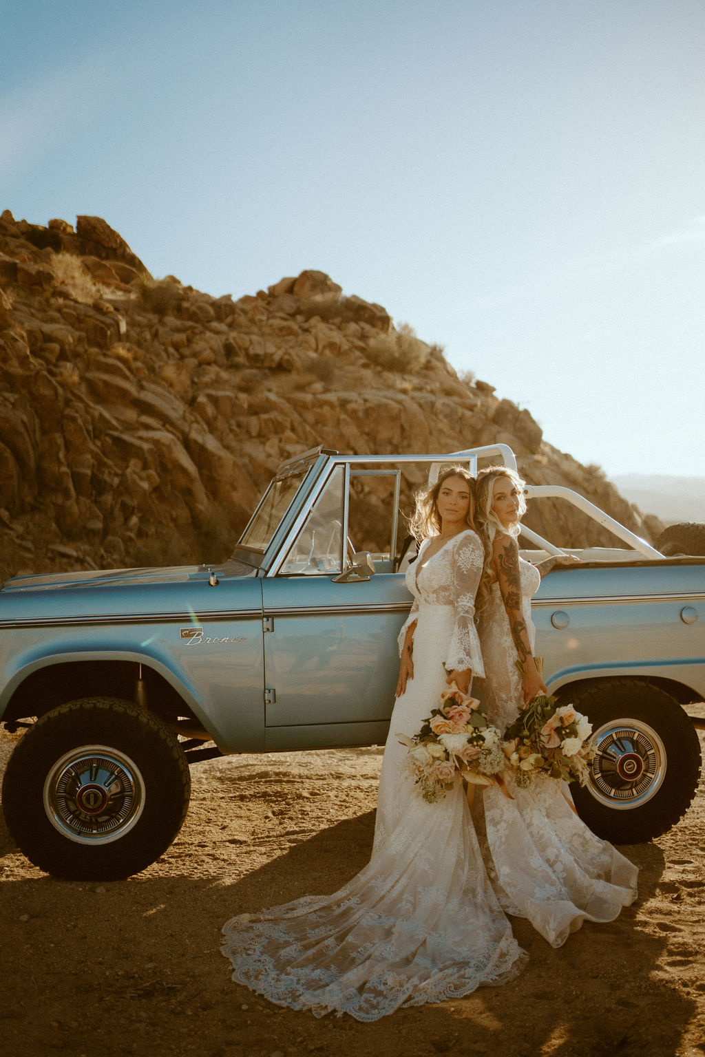 brides standing next to ford bronco in Joshua tree 