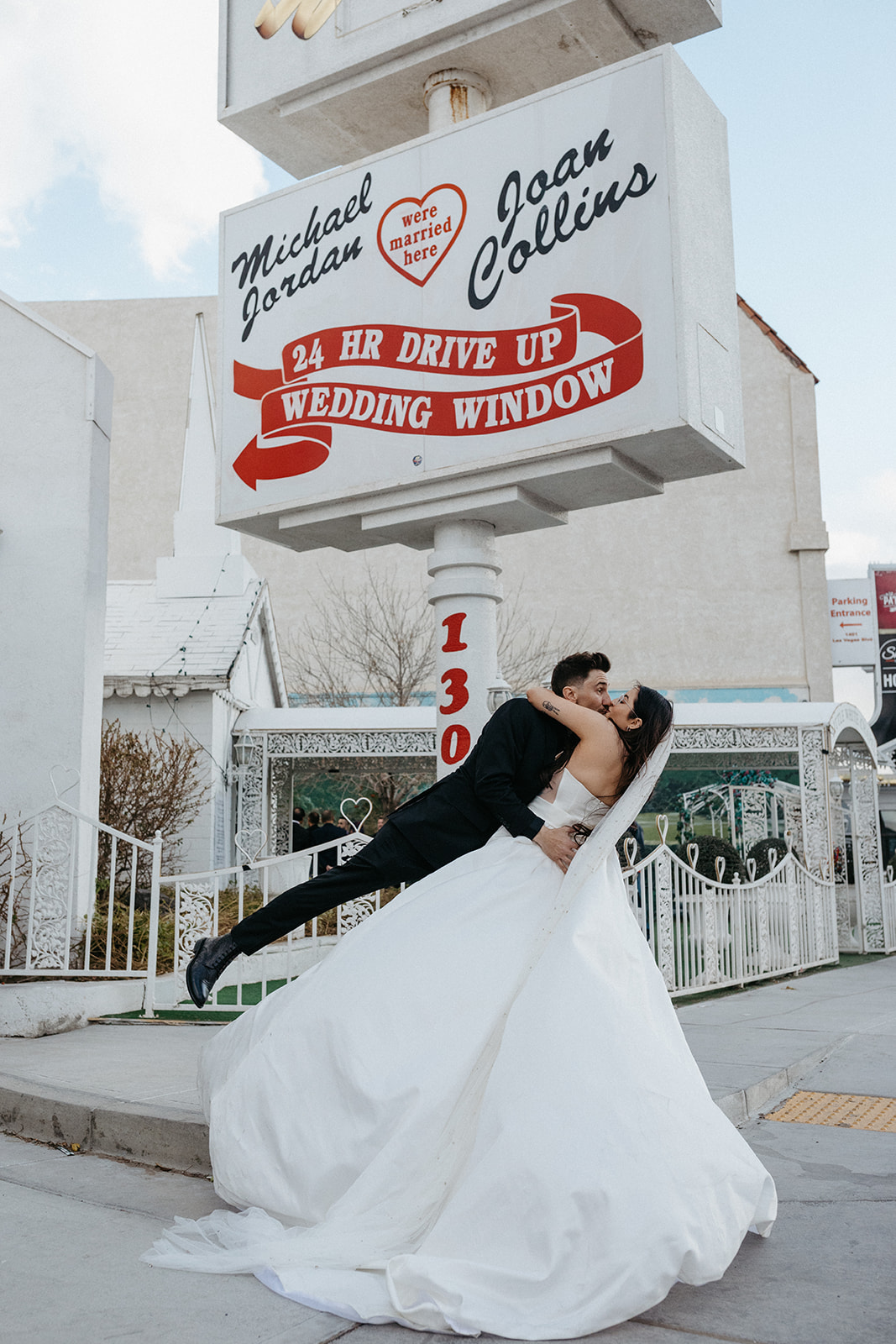 Newlyweds Kissing under Classic Chapel Sign 