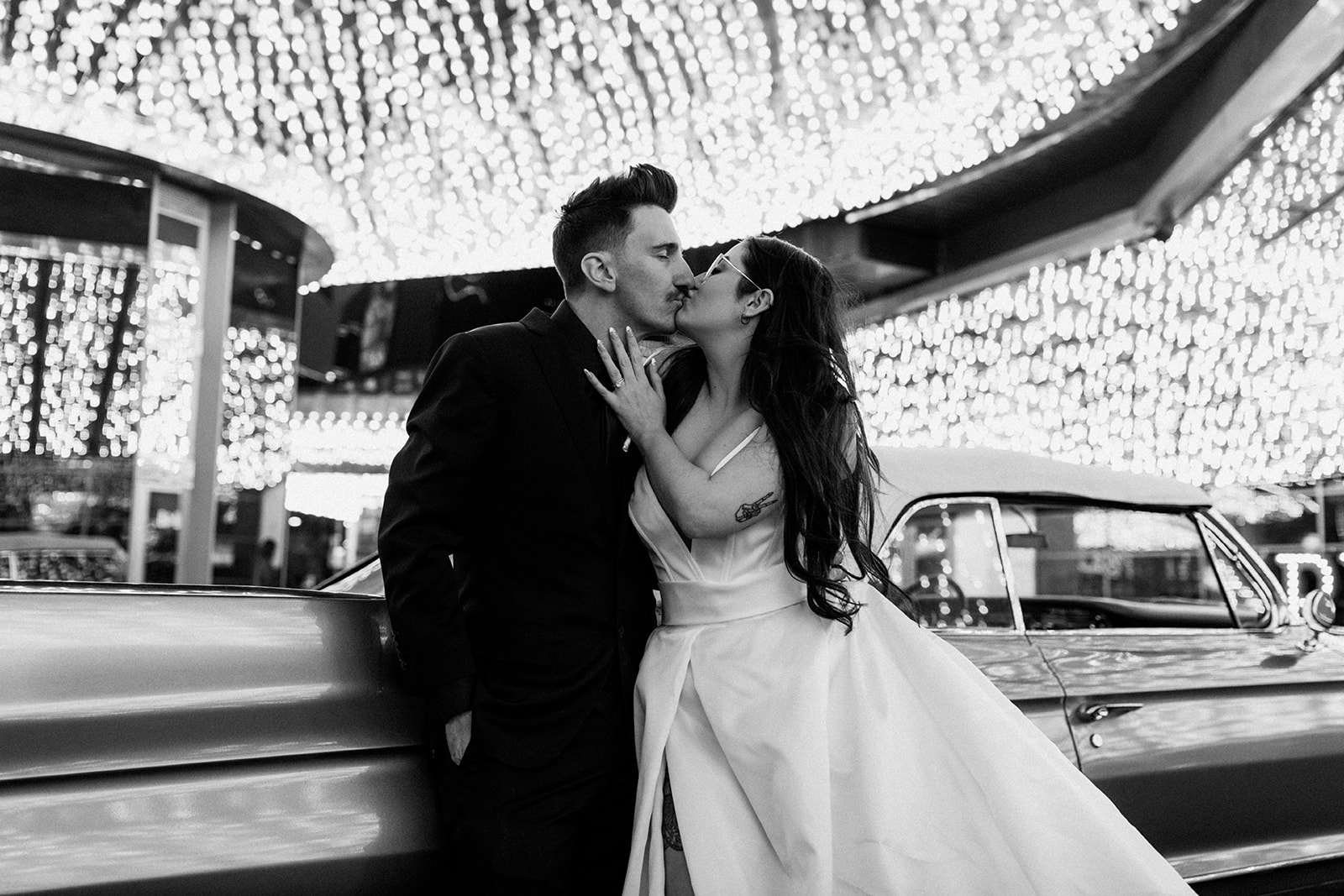 Black and White Photo of Bride and Groom Kissing in Downtown Las Vegas Casino 