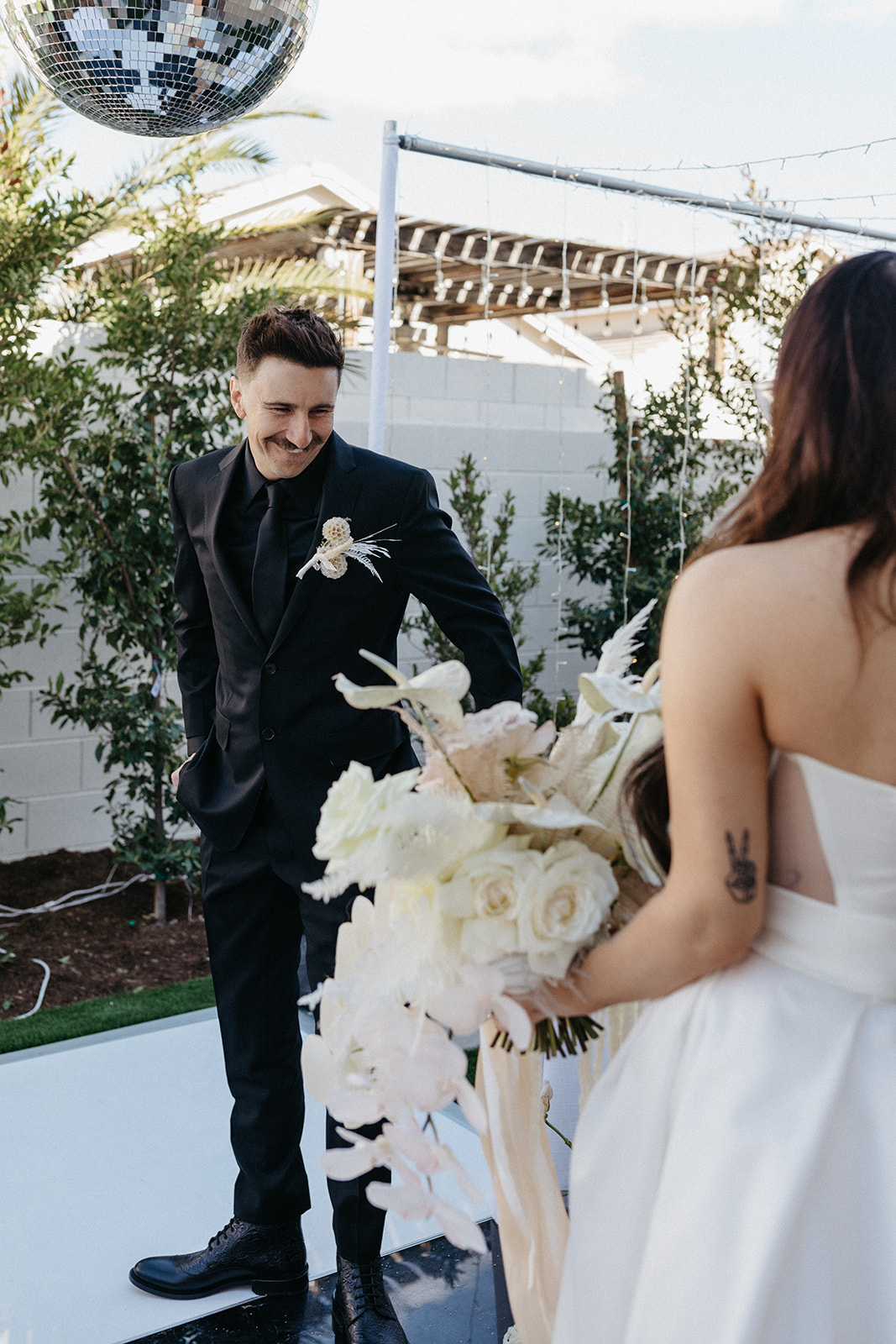 Grooms Reaction to Bride in First Look for Retro Modern and Romantic Las Vegas Wedding 