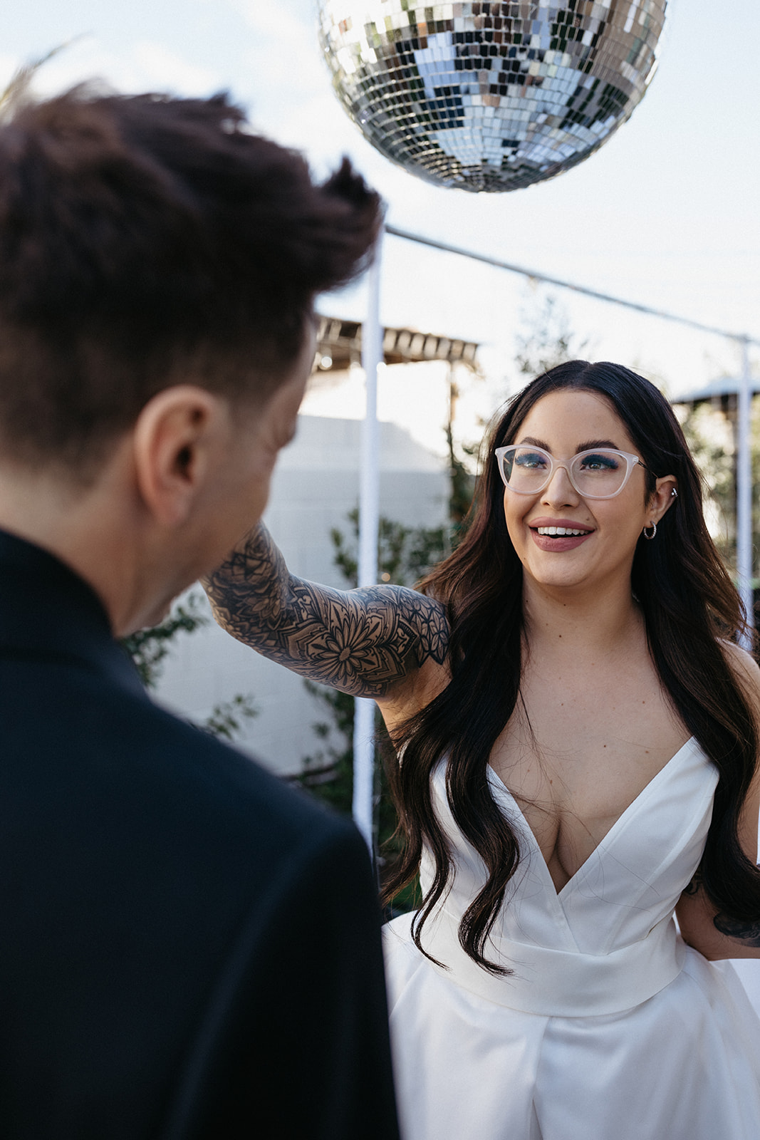 Bride with Clear Glasses Fixing Groom's Hair in Las Vegas Wedding 