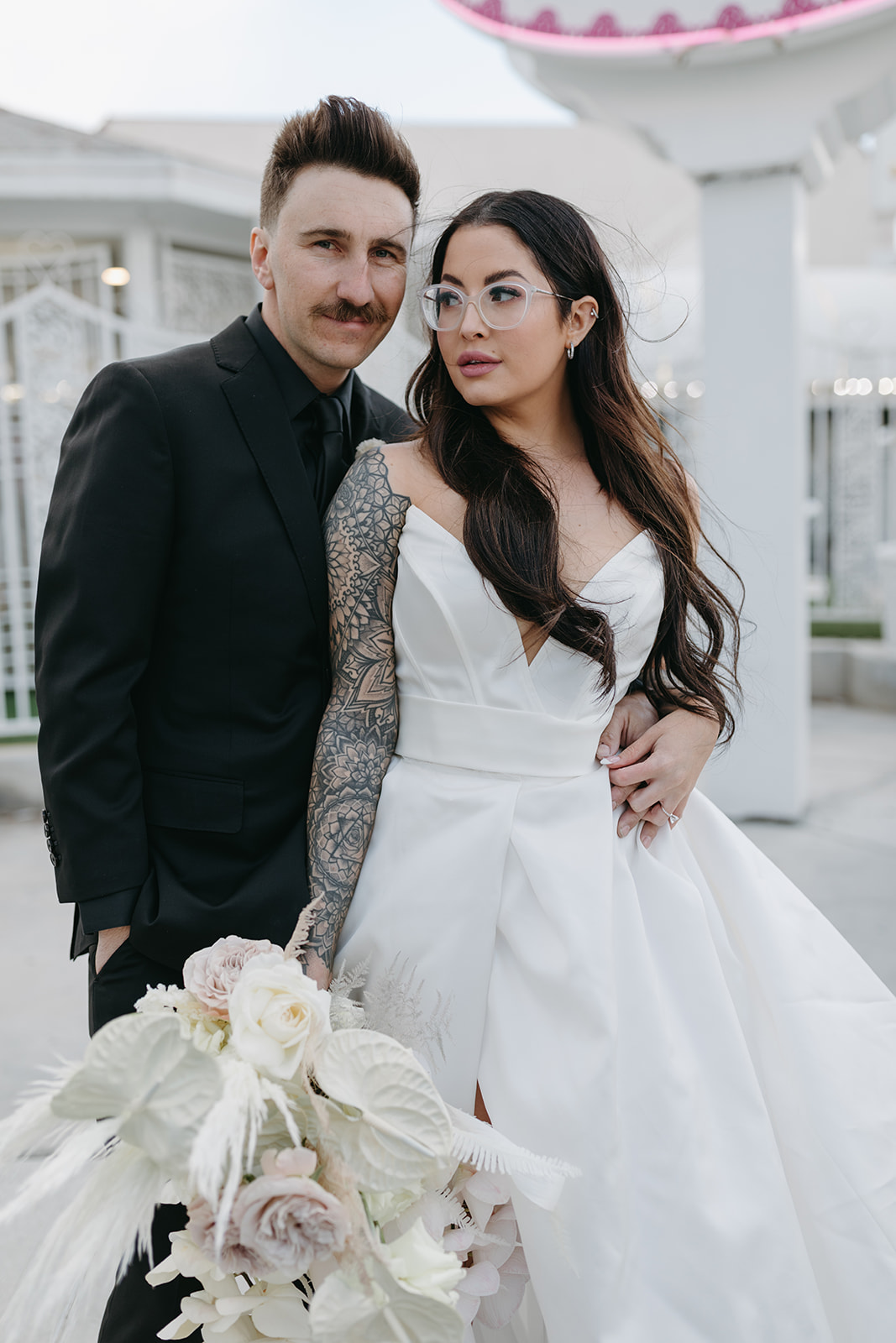 Groom in All Black Suite and Bride in White Dress and Neutral Toned Bouquet in Las Vegas 