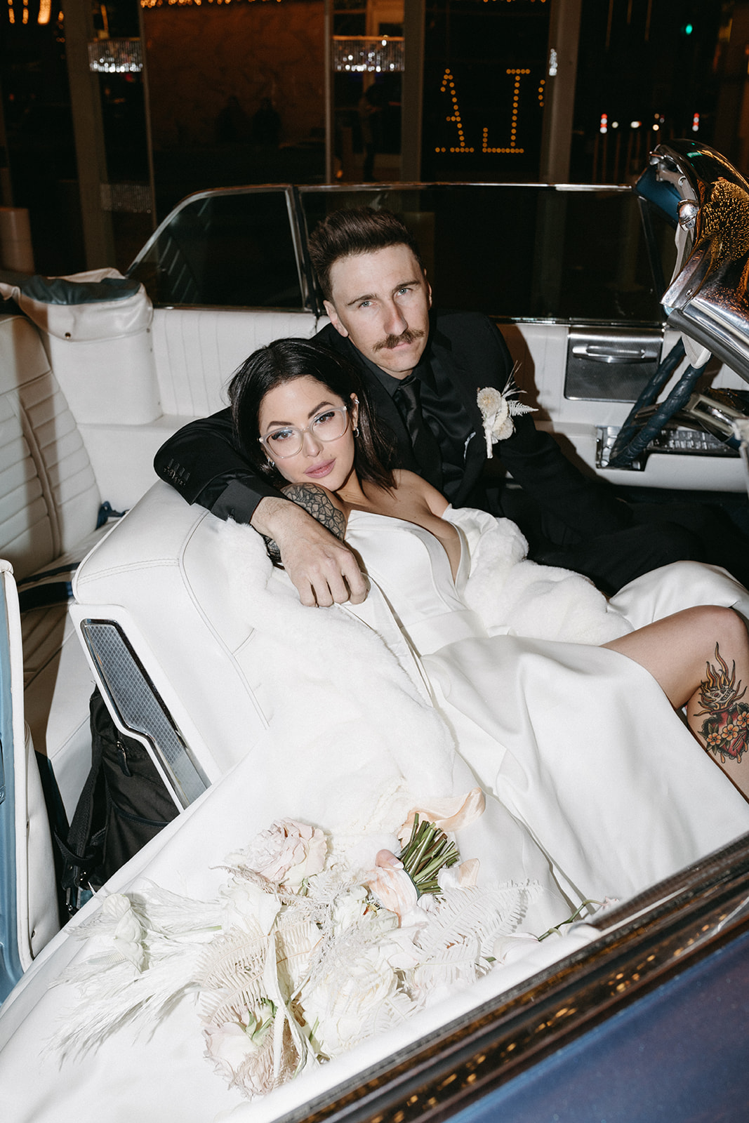 Newlyweds sitting in Classic Car in Las Vegas after A Little White Chapel Ceremony & Dinner Reception 