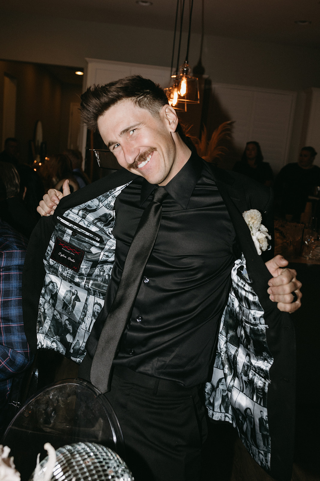 Groom Smiling and Showing his Custom Wedding Jacket with Photos sewn on the inside 