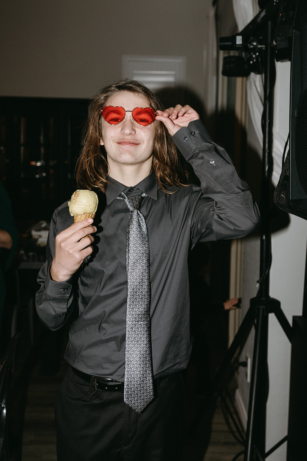 Guest wearing Red Glasses Party Favor & Eating Icecream during Modern Retro Vegas Reception 