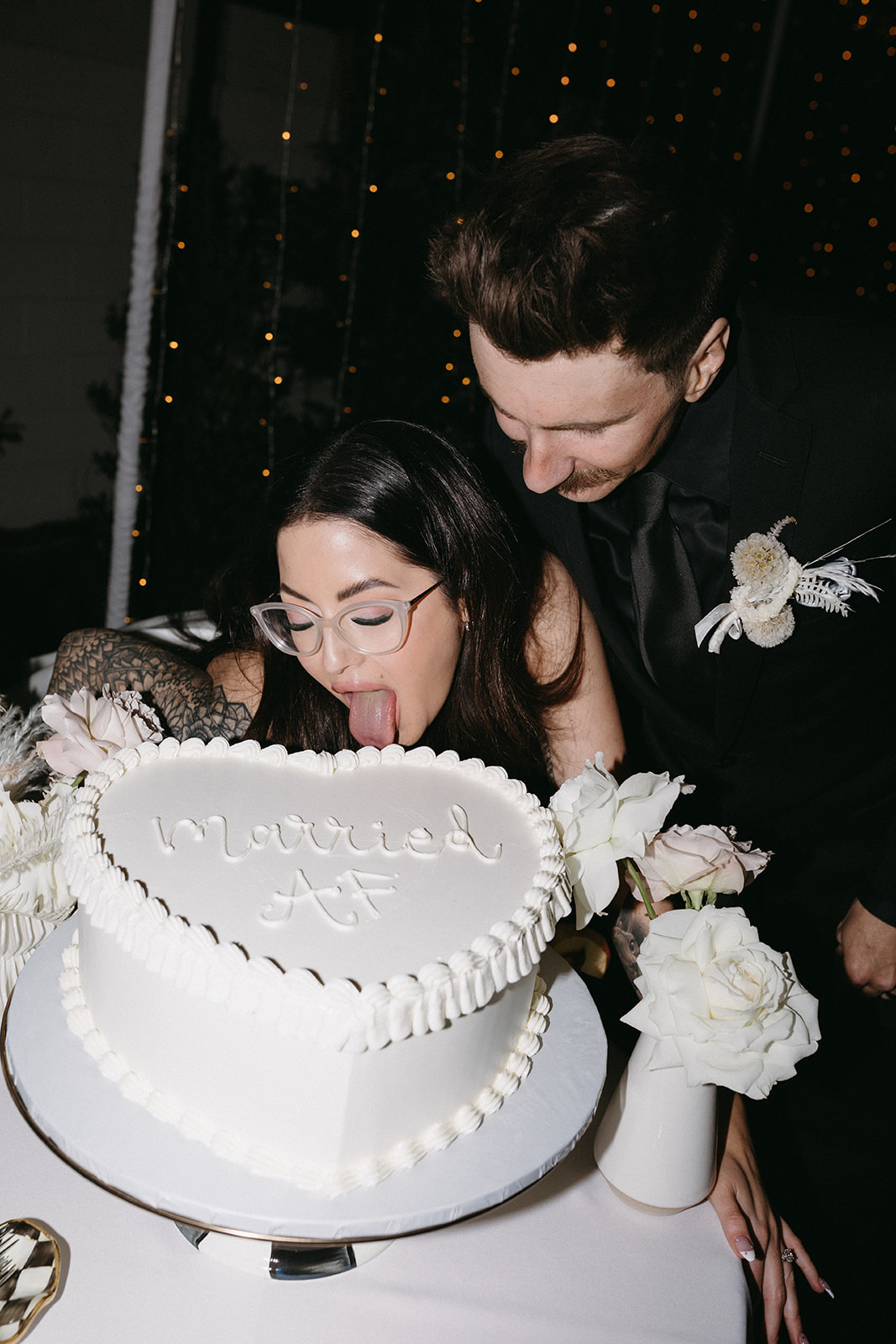 Newlyweds with Modern White Heart Shaped Cake with "Married AF" for Little White Wedding Chapel Modern Vegas Wedding