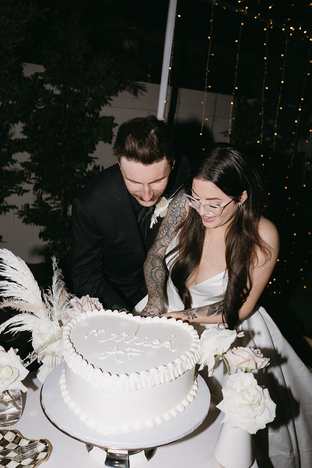 Couple Cutting "Married AF" Wedding Cake in Modern Vegas Vibes Wedding  