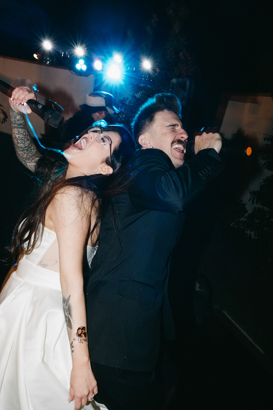 Bride & Groom Back to Back Singing Together during Reception during their Little White Wedding Chapel Modern Vegas Wedding