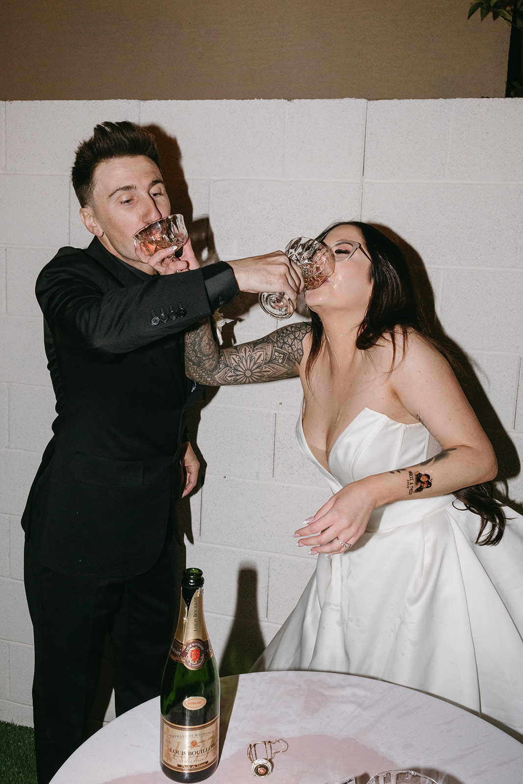Couple giving each other drinks after Little White Wedding Chapel Modern Vegas Wedding