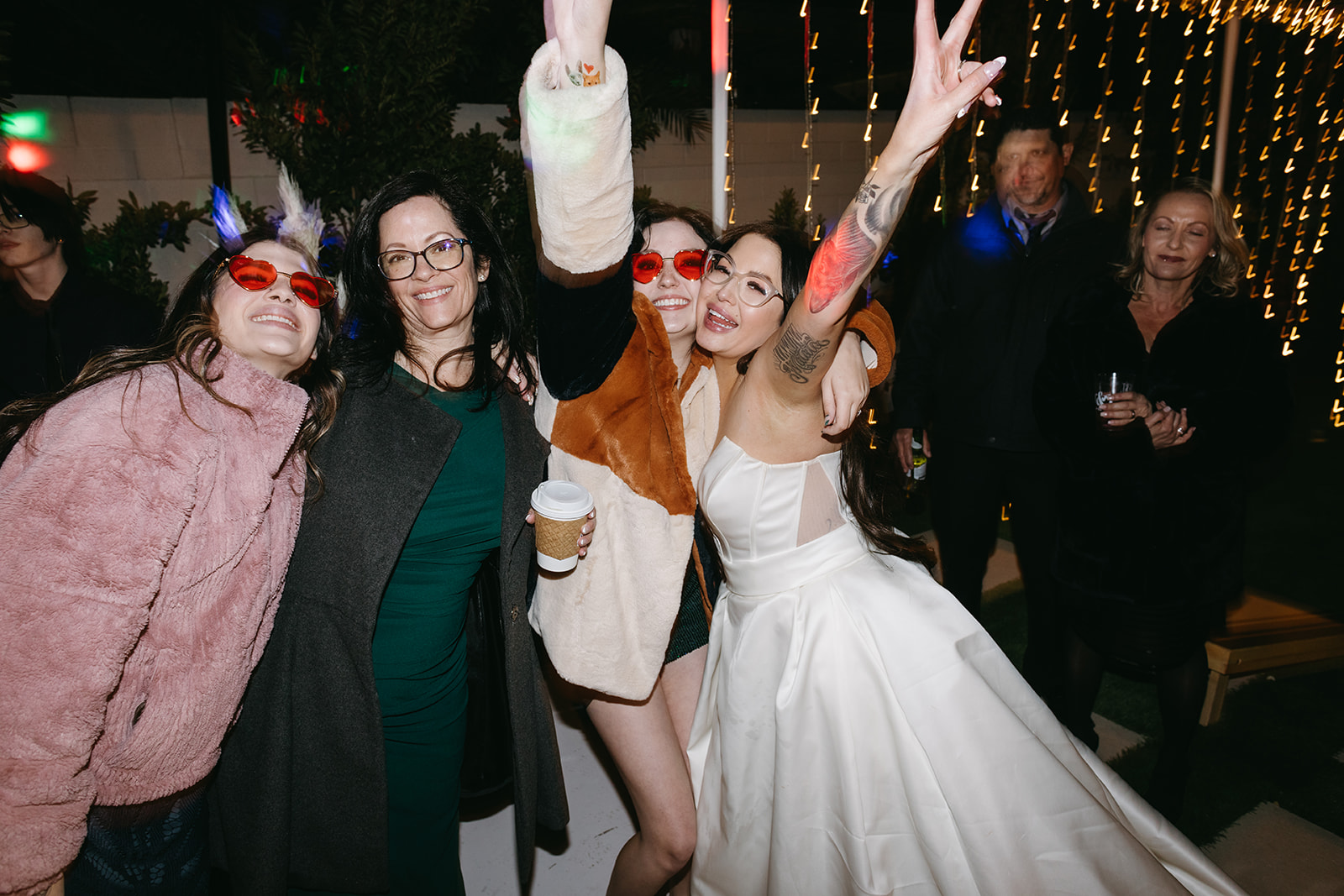 Guests wearing Red Glasses Party Favor during Modern Retro Vegas Reception 