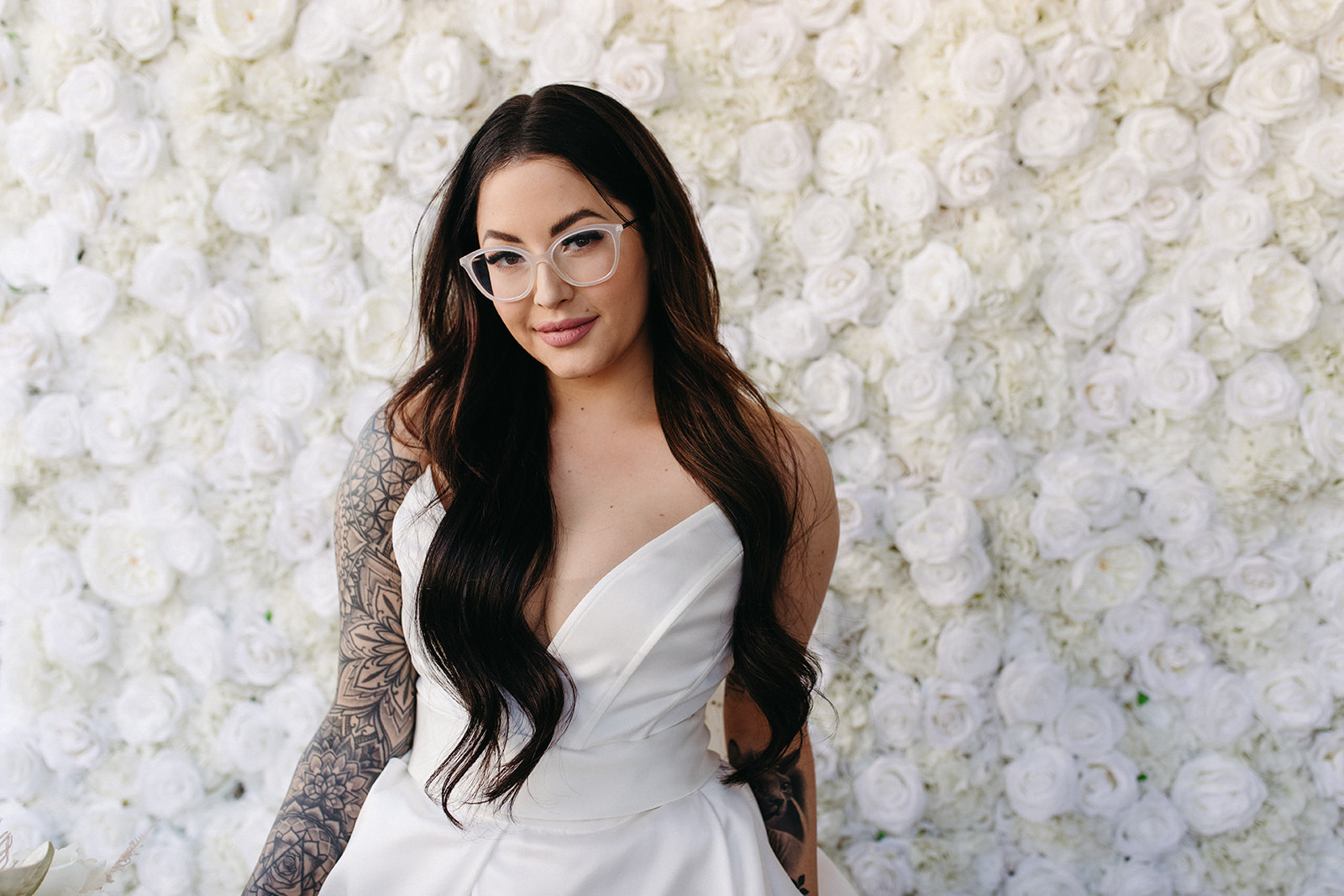 Bride in Front of White Floral Wall at Micro-Wedding Reception