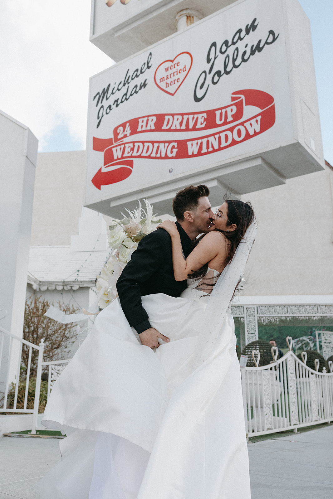 Bride and Groom after Ceremony in from of Sign during Little White Wedding Chapel Modern Vegas Wedding