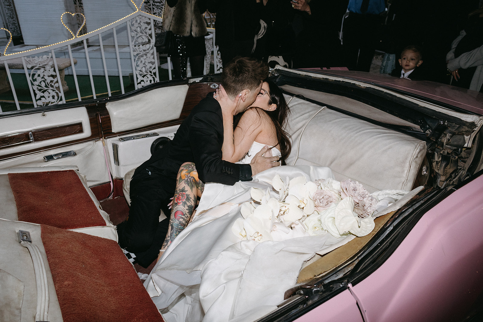 Newlyweds Kissing in Pink Cadillac in Little White Wedding Chapel Modern Vegas Wedding