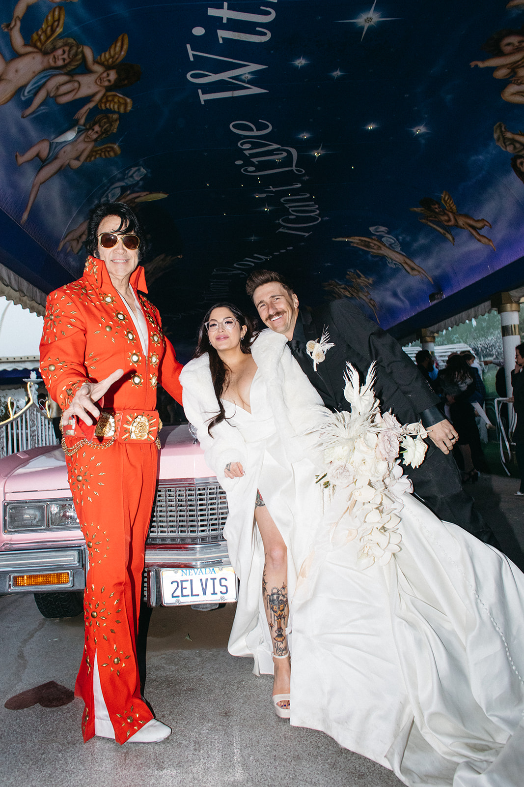 Newlyweds with Elvis Officiant and Pink Cadillac after Ceremony in Las Vegas 