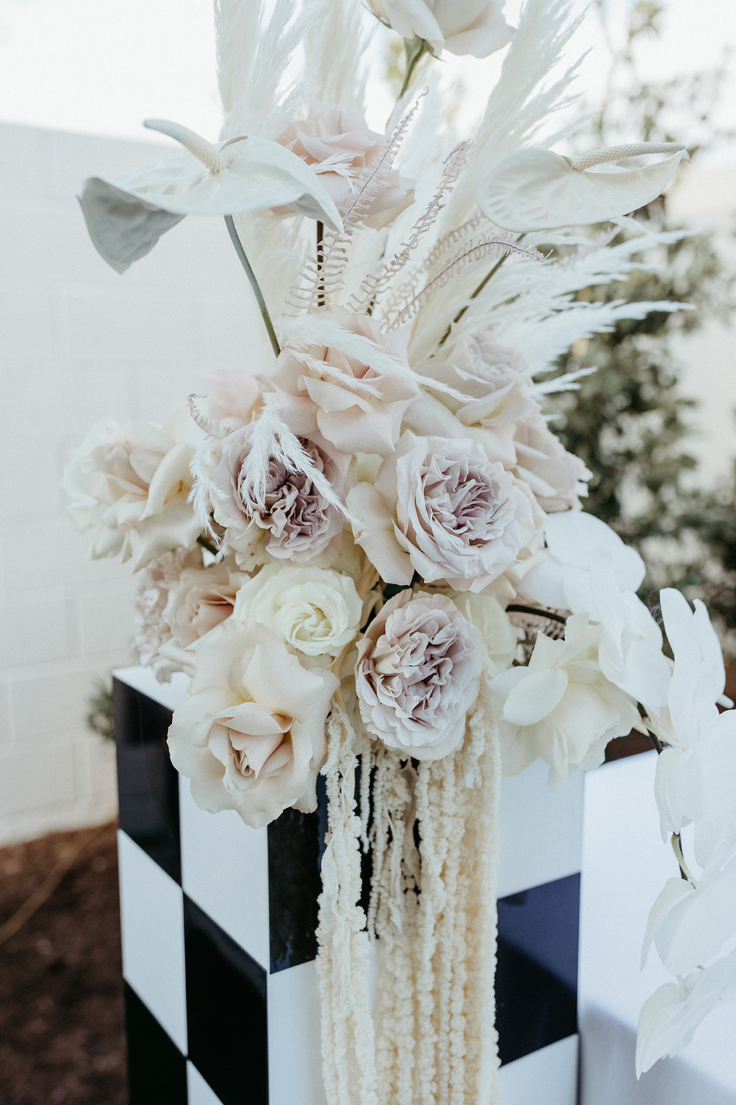 Modern and Romantic Neutral Colored Reception Florals with Checkered Black and White Stand 