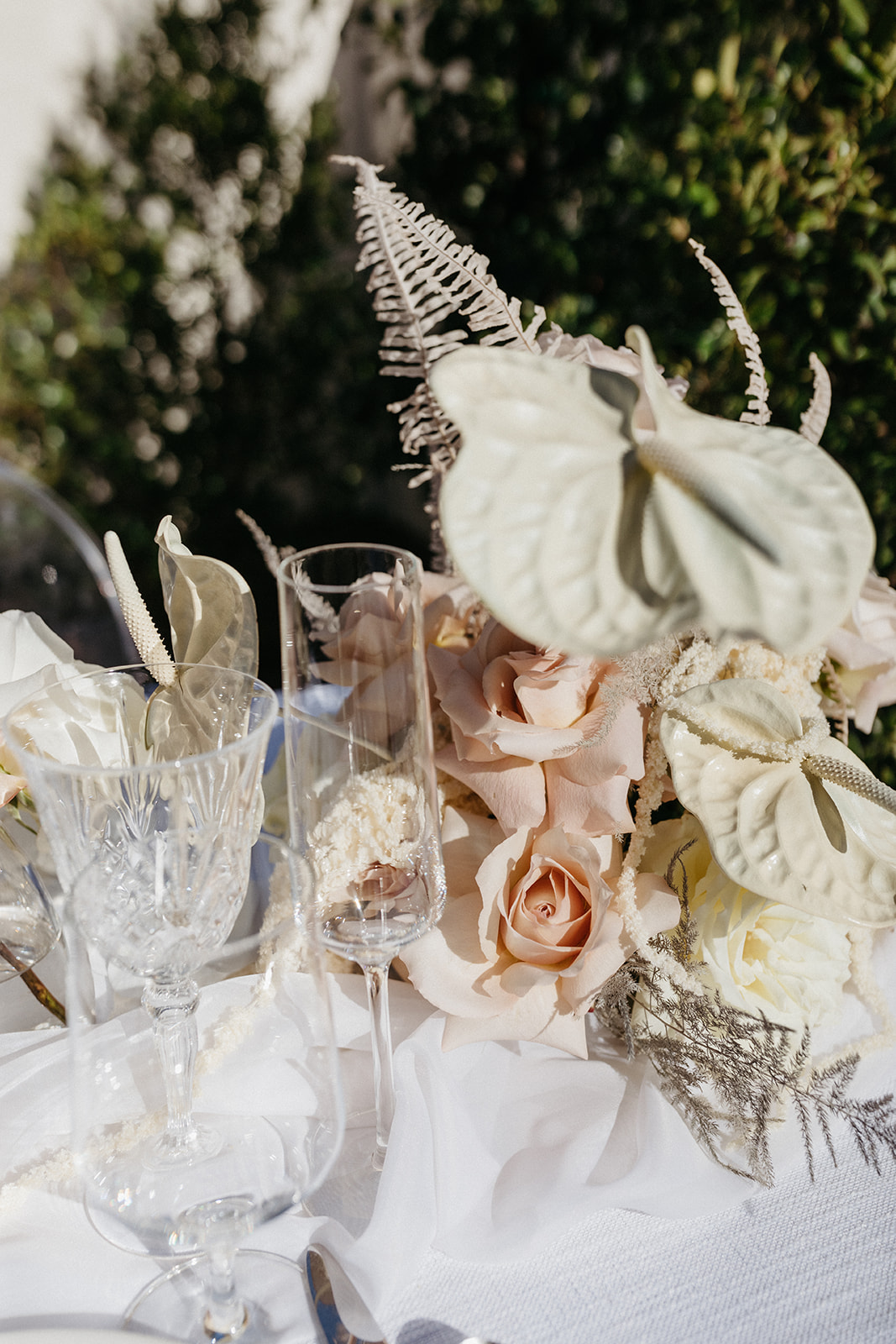 Champagne Glasses on Reception Table with Florals with White Anthurium 
