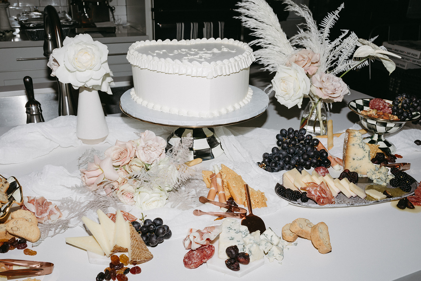 White Heart Shaped Cake on Table with Florals and Charcuterie for Las Vegas Micro-Wedding 