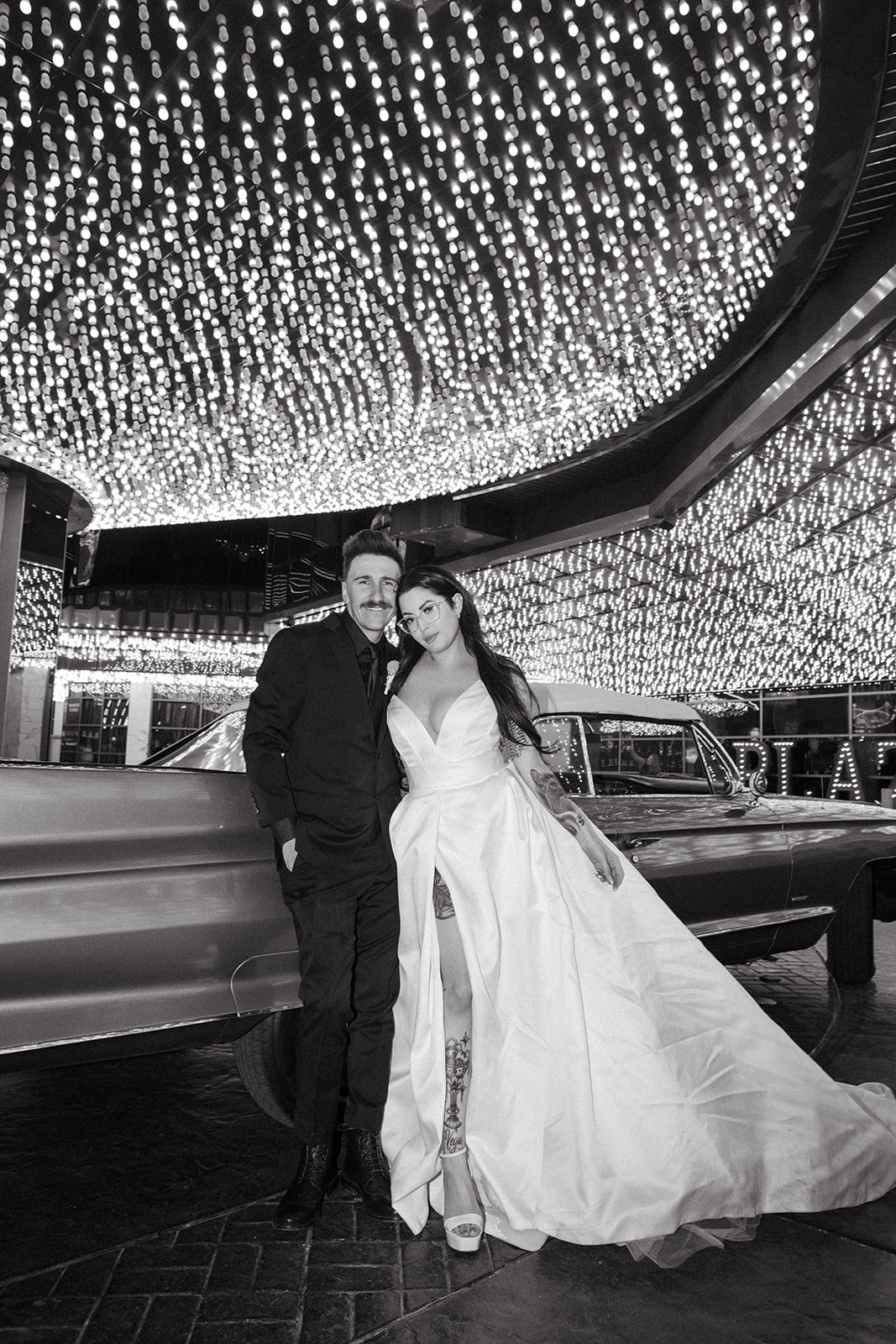 Black and White photo of Newlyweds under Downtown Las Vegas Hotel Lights 
